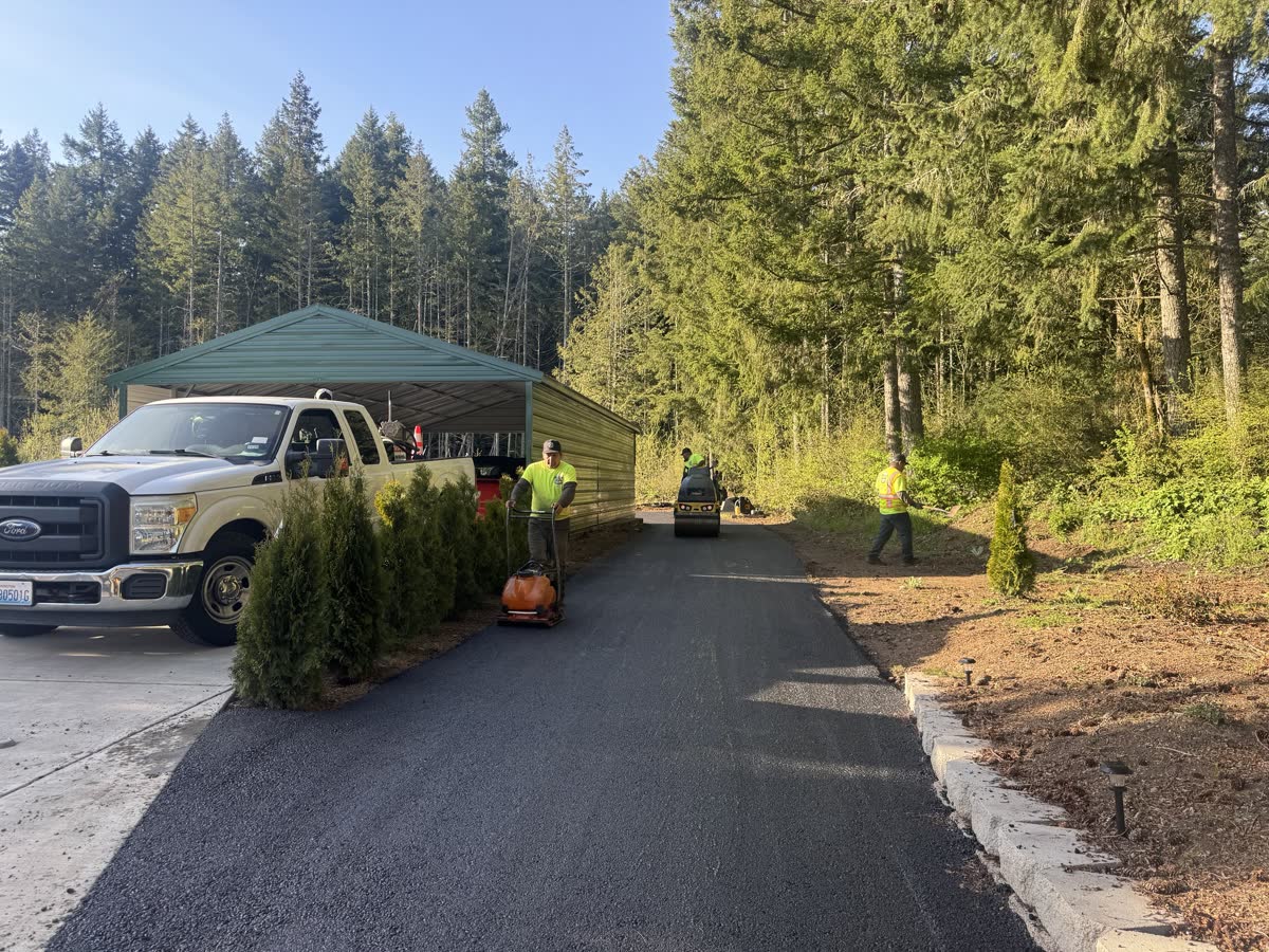 Coastal Asphalt Paving crew finishing fresh asphalt at a Northwest carport