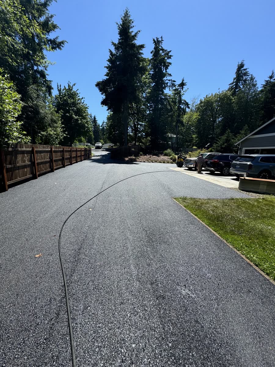 Fresh wide asphalt driveway to a home